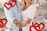 Composite image of happy couple holding their hands out