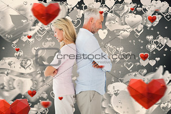 Composite image of unhappy couple not speaking to each other