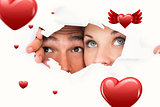 Composite image of young couple peeking through torn paper