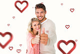 Composite image of attractive couple showing thumbs up to camera