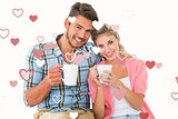 Composite image of attractive young couple sitting holding mugs