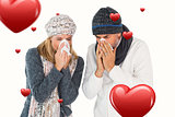 Composite image of sick couple in winter fashion sneezing