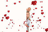 Composite image of happy couple showing large poster