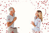 Composite image of happy couple holding large poster