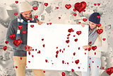 Composite image of attractive couple in winter fashion showing poster