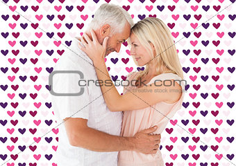 Composite image of affectionate couple standing and hugging