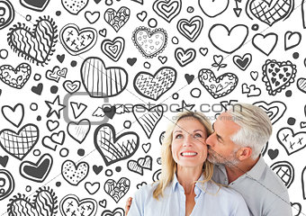 Composite image of affectionate man kissing his wife on the cheek
