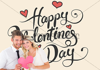 Composite image of attractive young couple holding pink heart