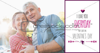 Composite image of happy mature couple hugging in the city