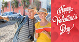 Composite image of happy tourist couple using guide book in the city
