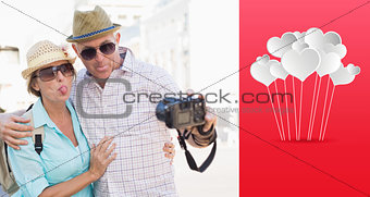 Composite image of happy tourist couple taking a selfie in the city