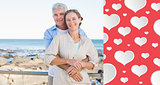 Composite image of happy casual couple hugging by the coast
