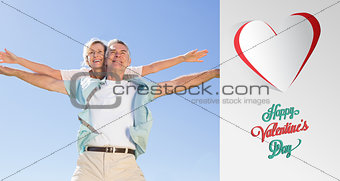 Composite image of happy senior man giving his partner a piggy back
