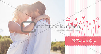 Composite image of attractive couple embracing by the road