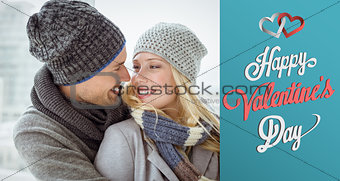 Composite image of cute couple in warm clothing smiling at each other