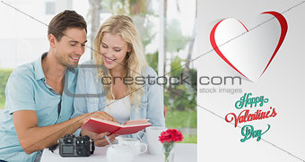Composite image of cute hipster couple reading book together at table
