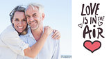 Composite image of attractive couple hugging at the beach smiling at camera