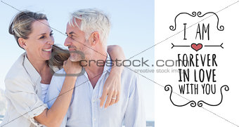 Composite image of attractive married couple hugging at the beach