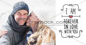 Composite image of attractive couple on the beach in warm clothing