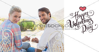 Composite image of happy young couple sitting in the garden enjoying wine together