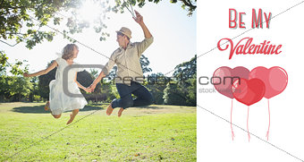 Composite image of cute couple jumping in the park together holding hands