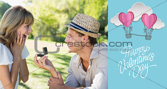 Composite image of man surprising his girlfriend with a proposal in the park