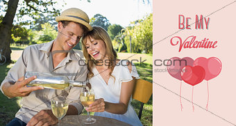 Composite image of cute couple drinking white wine together outside