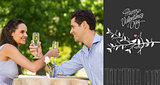Composite image of couple with champagne flutes sitting at outdoor café