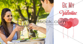 Composite image of couple toasting champagne flutes at an outdoor café