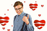Composite image of geeky hipster showing thumbs up