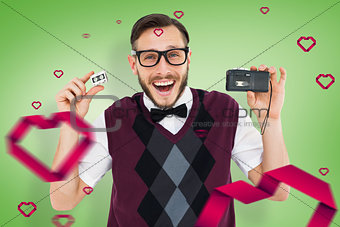 Composite image of geeky hipster holding a retro tape cassette player