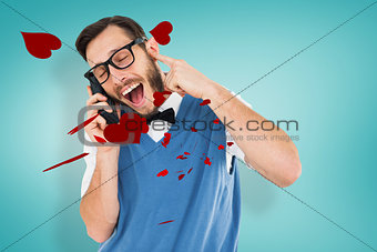 Composite image of geeky hipster talking on a retro cellphone