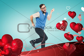 Composite image of geeky hipster dancing and smiling