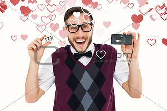 Composite image of geeky hipster holding a retro tape cassette player
