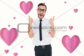 Composite image of geeky young man showing thumbs up