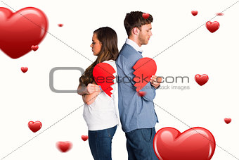 Composite image of side view of young couple holding broken heart