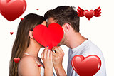 Composite image of side view of romantic couple holding heart