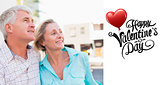 Composite image of happy mature couple sitting on bench in the city