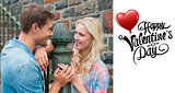 Composite image of hip young couple standing by railings