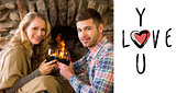Composite image of romantic couple toasting wineglasses in front of lit fireplace