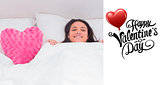 Composite image of woman lying in bed next to a fluffy heart pillow