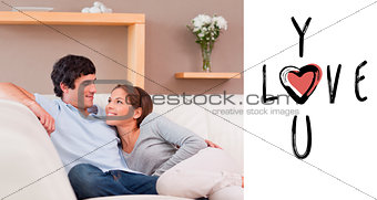 Composite image of couple on the sofa in love