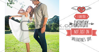 Composite image of cute couple dancing in the park and laughing
