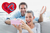 Composite image of man surprising his delighted girlfriend with a pink gift on the sofa