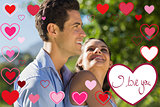 Composite image of loving and happy young couple at park