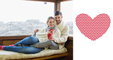 Composite image of couple in winter wear with coffee cups against cabin window