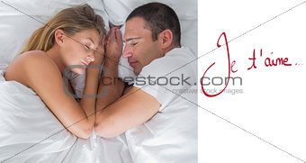 Composite image of cute couple lying asleep in bed