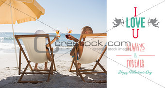 Composite image of happy couple drinking cocktails while relaxing on their deck chairs