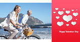 Composite image of smiling couple riding their bikes on the beach