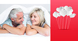 Composite image of closeup of a mature couple lying in bed
